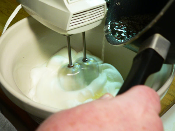 Seven Minute Frosting, add sugar in a slow stream.