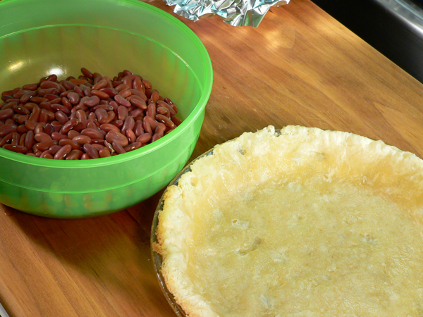 Basic-Pie-Crust_39_remove-beans-and-foil Basic Pie Crust, remove the beans and foil.