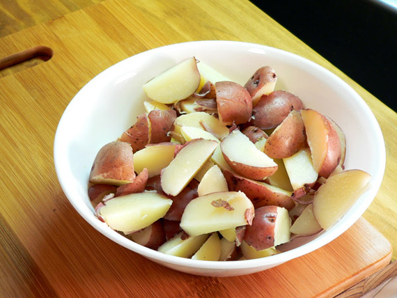 Garlic-Dill-New-Potatoes-bowl-13 Place the potato wedges in a serving bowl.