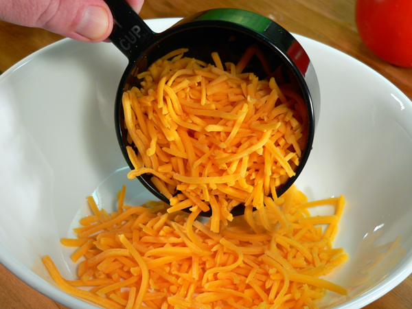 Tomato-Pie_14_add-cheddar-cheese Tomato Pie Recipe, add the cheddar cheese.